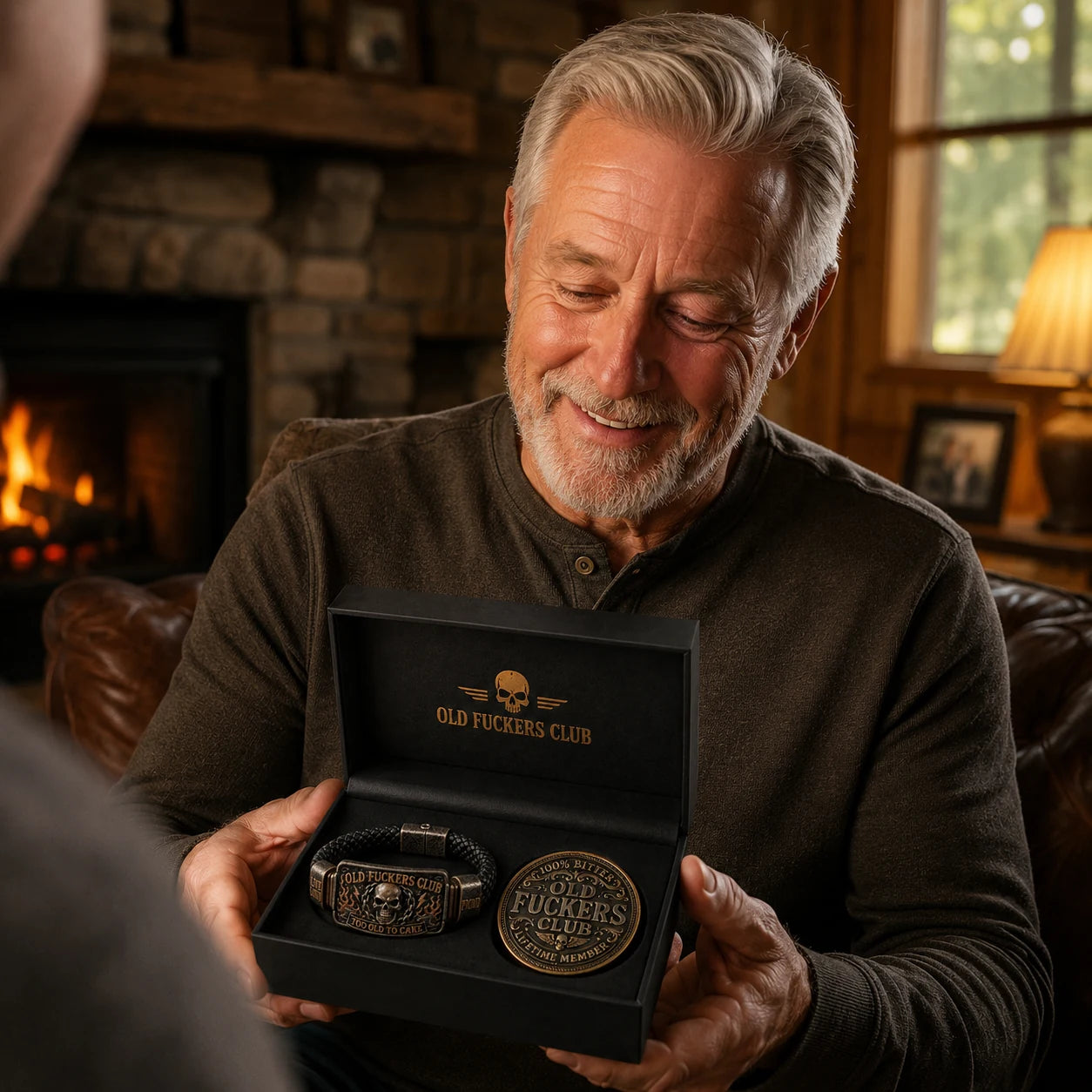 Older man smiling while receiving the Old Fuckers Club bracelet and coin gift set